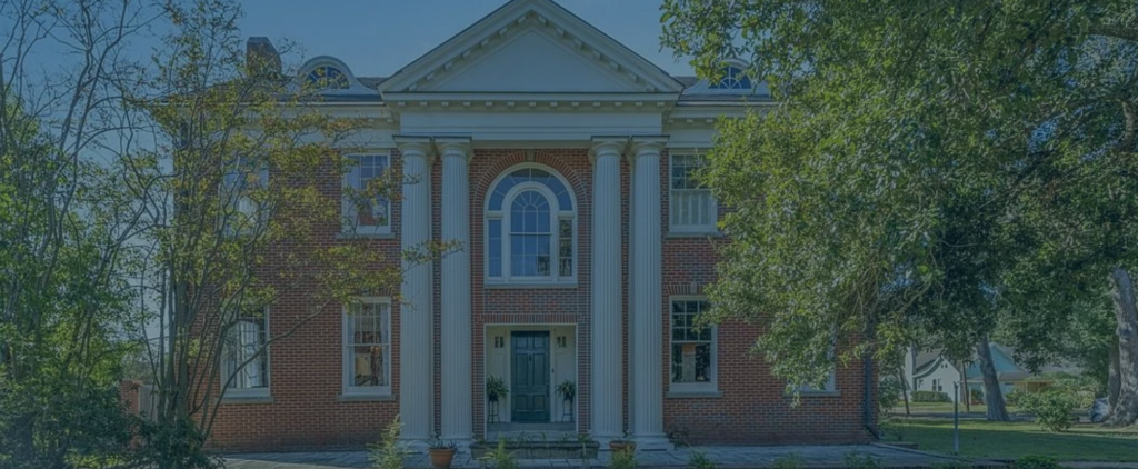 exterior of a stately brick home with trees