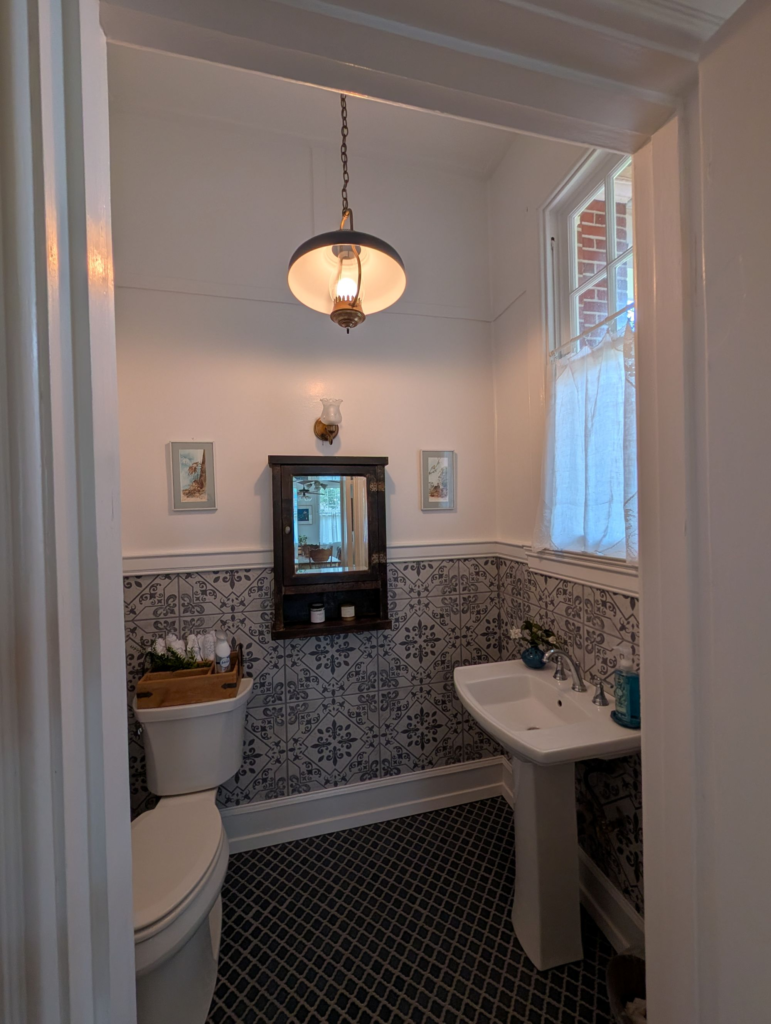 blue powder room with vintage curtains