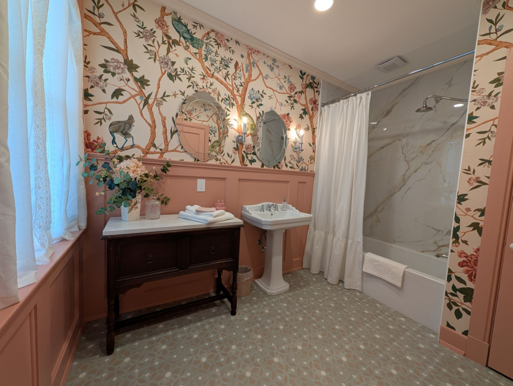 bathroom with vintage wallpaper and furniture