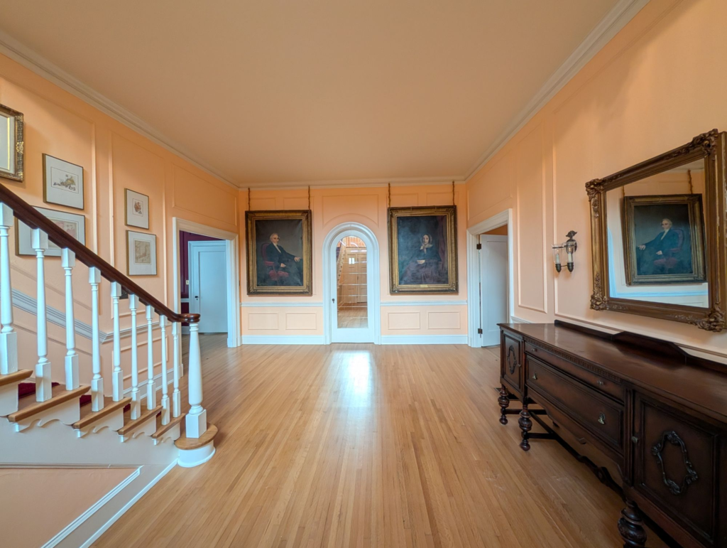 entry with staircase, antique portraits and furniture